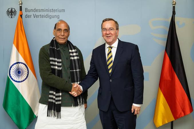Boris Pistorius shaking hands with India's Defence Minister Rajnath Singh between the Indian and German flags at the Federal Ministry of Defence